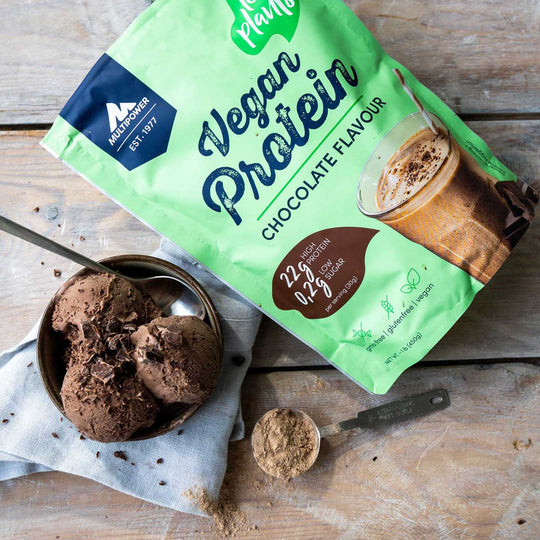 Multipower Proteinpulver vegan Schokolade im grünen Beutel und Schokoladeneis daneben